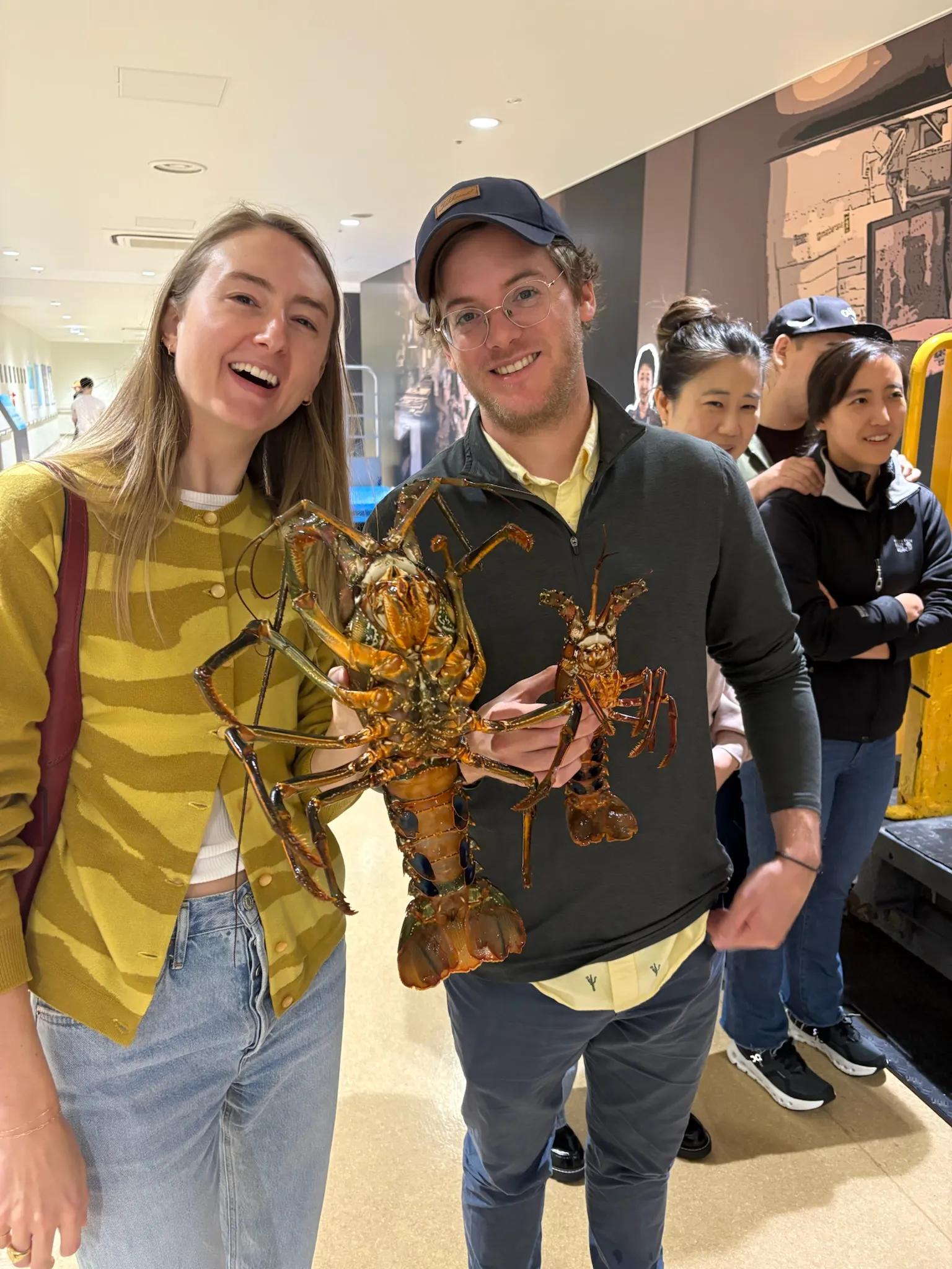The two of us holding lobsters at a Korean market