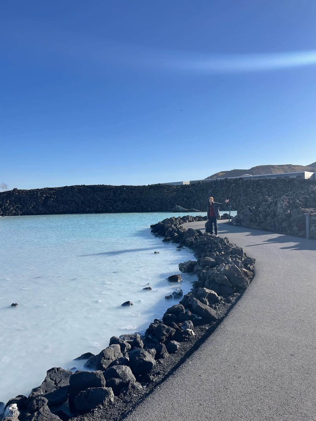 Bathers in the milky-blue water winding between black lava at the Blue Lagoon
