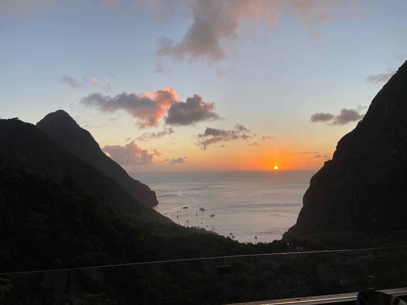 The sun setting on the sea framed between the two Pitons from Ladera
