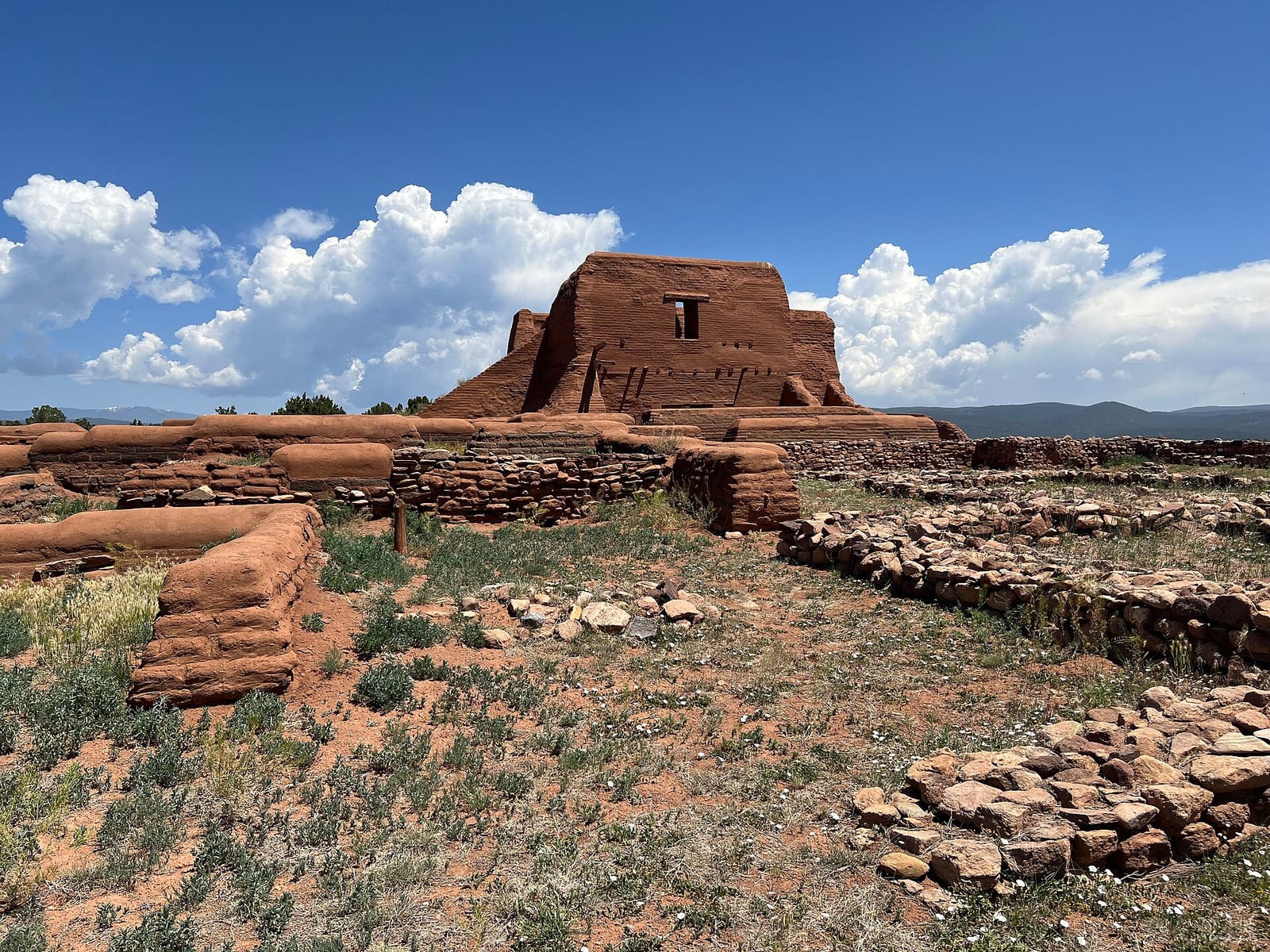 The adobe mission church ruins at Pecos, with the pueblo foundations in front