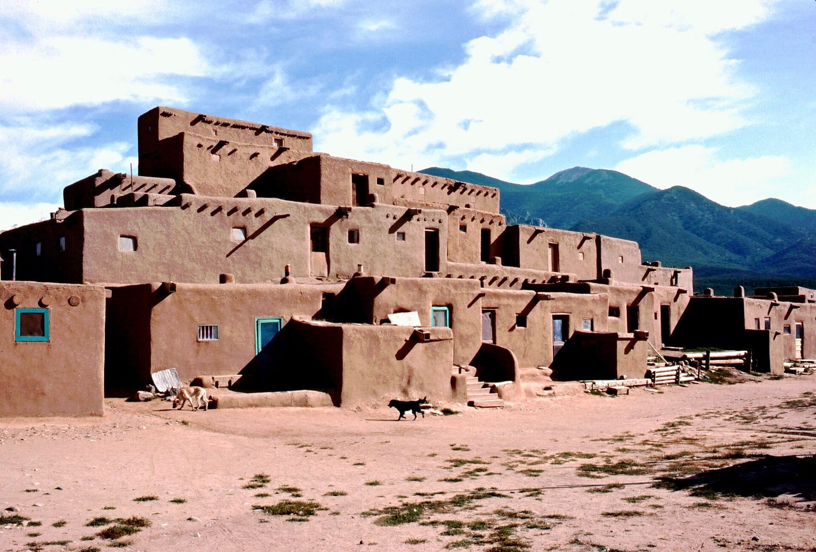 The multi-storey adobe dwellings of Taos Pueblo below the Sangre de Cristo mountains