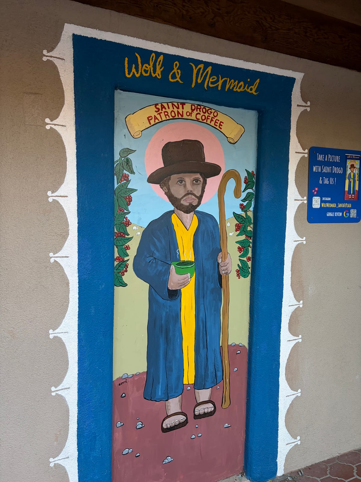 A door painted with Saint Drogo, patron of coffee, at Wolf and Mermaid in Santa Fe