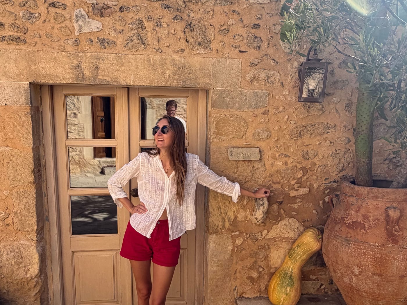 A honey-stone doorway and olive tree in a terracotta pot at Kapsaliana Village, Crete